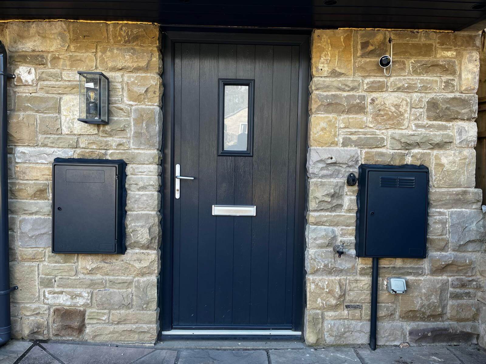 Black front door and utility boxes