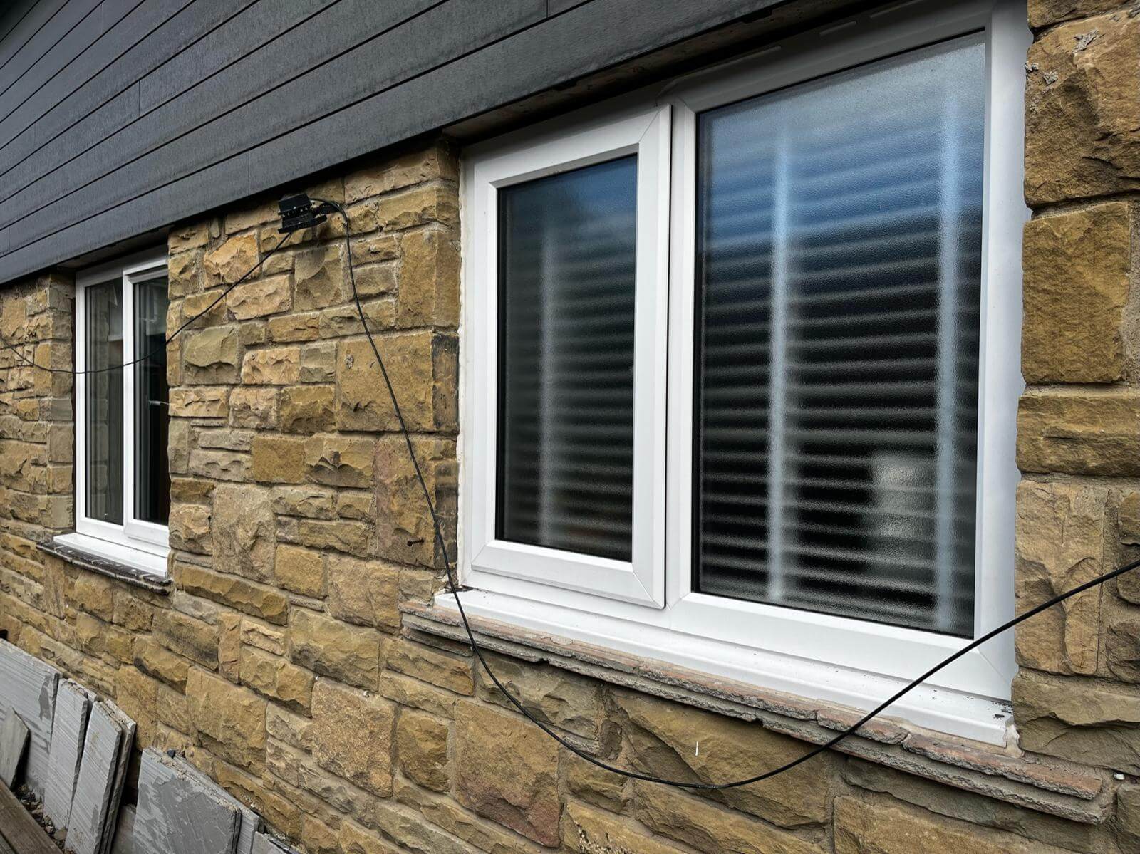 Windows against stone wall